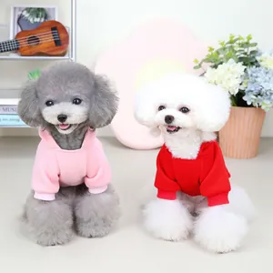 Pink and red hooded dog hoodies for small pets made of soft knit fabric in cozy setting