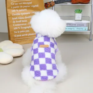 Detail of purple and white checkered pet fleece vest with a brown leather label