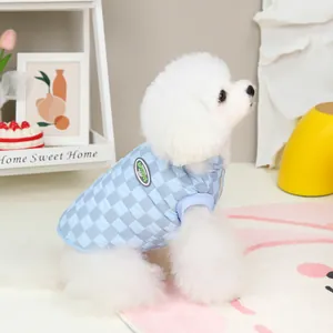 Quilted light blue checkerboard pet vest for small dogs in a cozy home setting