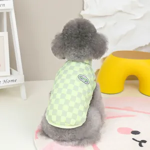 Detail view of checkerboard quilted pet vest in light green with an embroidered badge