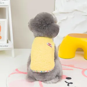 Detail of yellow fleece pet vest featuring floral trim and Happy Every Day embroidery