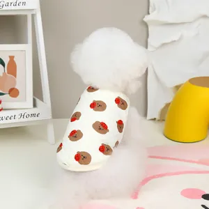 Close-up of a white quilted pet vest featuring cute brown bear prints and yellow trim