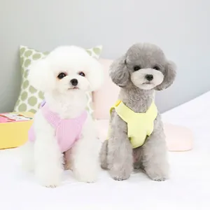 Pink and yellow waffle knit pet vest for small dogs featuring back buckle closure