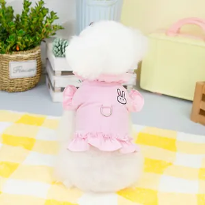 Detailed back view of a pink pet harness dress with rabbit embroidery and ruffles