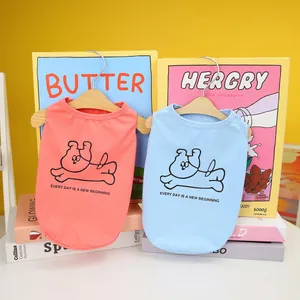Close-up of breathable cotton pet vests in pink and blue with cartoon dog prints
