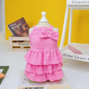 Close-up of pink seersucker pet dress featuring triple-layered skirt and bow detail