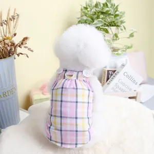 Detail of pink and blue plaid cotton pet dress with white buttons and a metal D-ring for leash