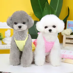 Close-up of pink and yellow layered candy pet dresses for small dogs and cats