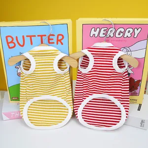 Close-up of striped pet vests in yellow and red with soft knit texture and white piping