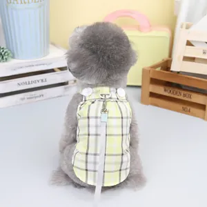 Close-up of a plaid dog harness with decorative buttons and matching white leash