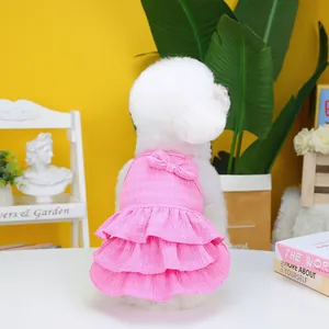 Detailed pink tiered pet dress with ruffled layers and a decorative bow on the back