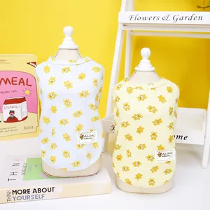 Detail of soft cotton pet t-shirt with cute bear print on a yellow background