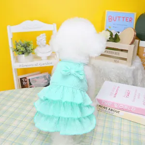 Detail of mint green pet dress featuring a back bow and three-layer ruffled hem design