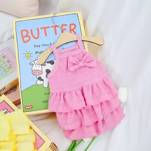 Close-up of pink tiered seersucker pet dress with ruffles and a delicate bow detail