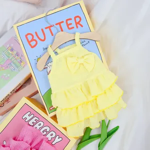 Detailed macro view of yellow multi-layered ruffled pet dress with a cute bow decoration