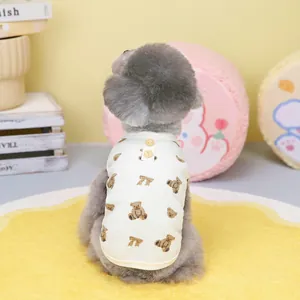 Detail of white waffle pet vest with brown bear print and wooden buttons