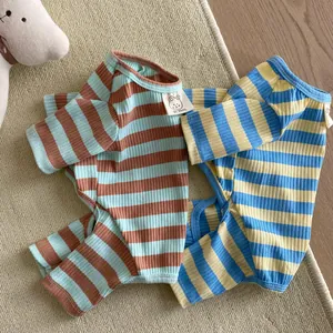 Close-up of soft striped cotton pet pajamas with ribbed texture and woven bear label