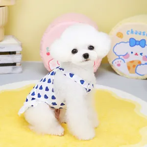 Cute pet summer dress with blue heart prints and lace trim on a small white dog