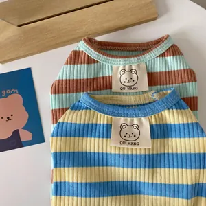 Macro shot of striped cotton pet pajamas with ribbed texture and small bear tags