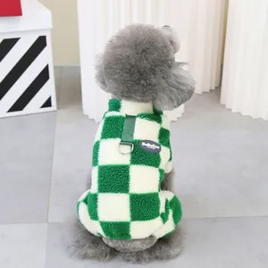 Detail of green checkered fleece pet vest with built-in harness D-ring and brand label