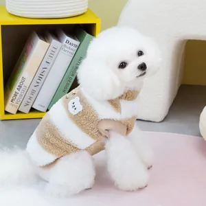 Brown striped fleece pet vest with bear patch and D-ring on a small white dog