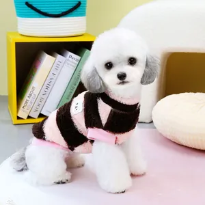 Cozy striped dog sweater with white bear patch on a small white poodle dog