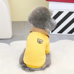 Detail of yellow pet sweatshirt with checkered collar and bear embroidery on the back