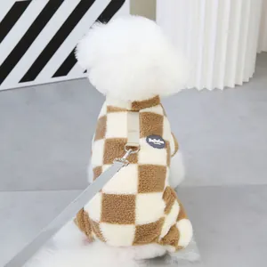 Detail of checkered sherpa pet fleece with metal D-ring leash attachment and nylon strap