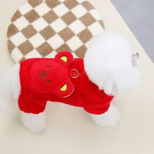 Detail of red plush dog vest featuring a 3D bear head and metal D-ring for leash attachment