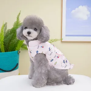Pink quilted cotton pet vest with bear prints on a gray poodle in a cozy home setting