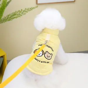 Close-up of quilted yellow pet vest with cute animal embroidery and matching leash