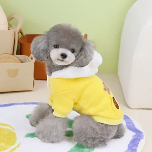 Yellow pet hoodie with fleece hood and bear patch worn by a small poodle dog