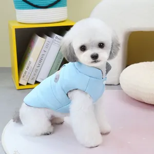 Quilted light blue pet vest for small dogs featuring a cute bear patch and button closure