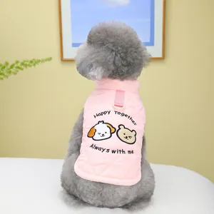 Pink quilted pet vest with cartoon dog embroidery and leash D-ring on a grey poodle