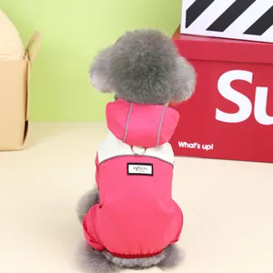 Pink and white pet raincoat detail showing reflective strips and metal traction ring