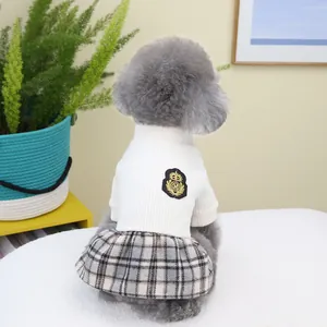 Detailed view of British style pet school uniform with plaid skirt and embroidered M badge