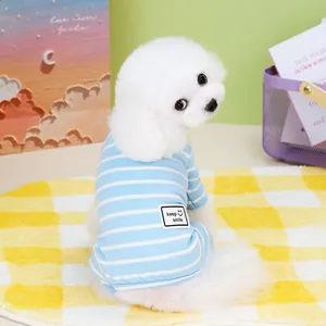Close-up of blue and white striped pet t-shirt with keep smile patch on a small dog