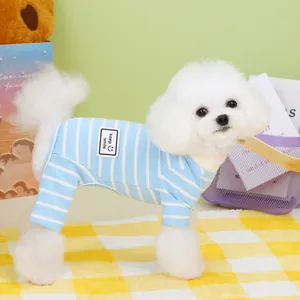 Blue and white striped dog pajamas with keep smile patch on a bichon frise model