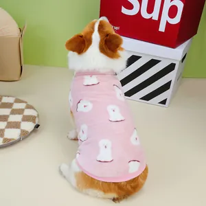 Close-up of pink fleece pet vest with white dog patterns on a Corgi model