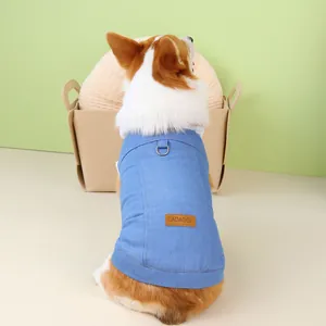 Detail of light blue denim pet vest with metal D-ring and brown leather tag for Corgi