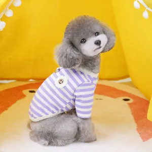 Striped purple and white pet cardigan with a smiley flower patch on a gray poodle