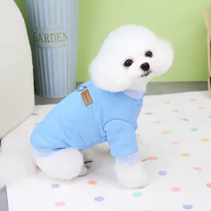 Sky blue quilted cotton pet vest with D-ring leash attachment on white Bichon Frise dog