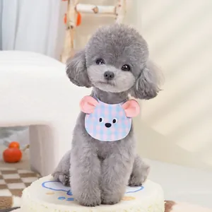 Pink and blue checkered pet bib with cartoon embroidery on a small dog model
