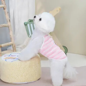 Pink and white striped pet vest for cats and dogs shown on a bichon frise dog