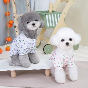 Close-up of floral pet shirts with lace doll collars and ruffle cuffs for small dogs
