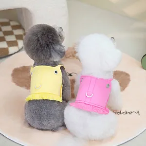 Bright yellow and pink pet harness vests with fringe tassels and metal D-rings for small dogs