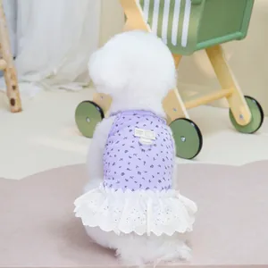 Detail of floral pet dress with double-layered lace hem and bear pattern tag