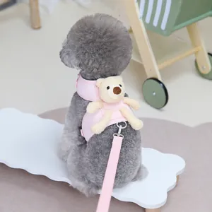 Close-up of pink pet harness with plush bear decor and matching leash for small dogs