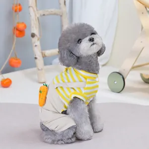 Detail of yellow striped pet shirt with beige overalls featuring a plush carrot charm