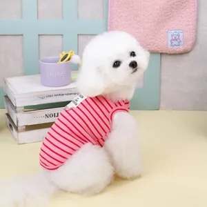 Détail du gilet rayé rose pour chien avec anneau en D et étiquette sur chien blanc